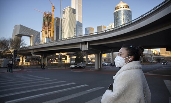 Девушка в защитной маске на улице в Пекине